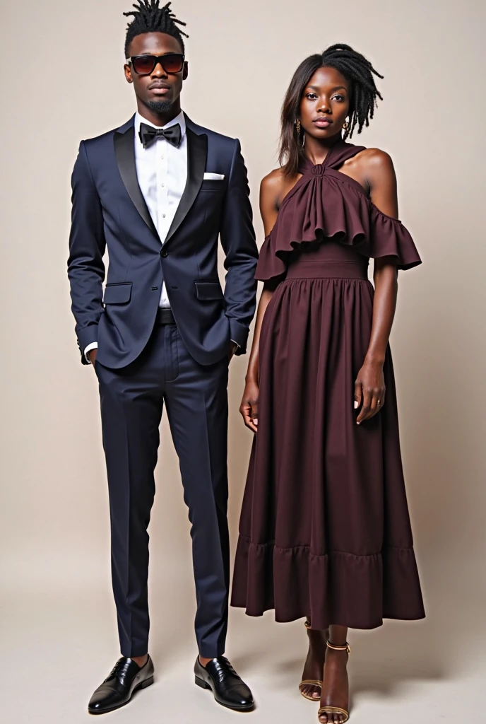 Beautiful Black woman wearing office dark blue dress. Three quarter portrait on white background. Straight posture. She wears beauty amber earrings and amber beads. A handsome man in suit stays behind her and holding her shoulders.