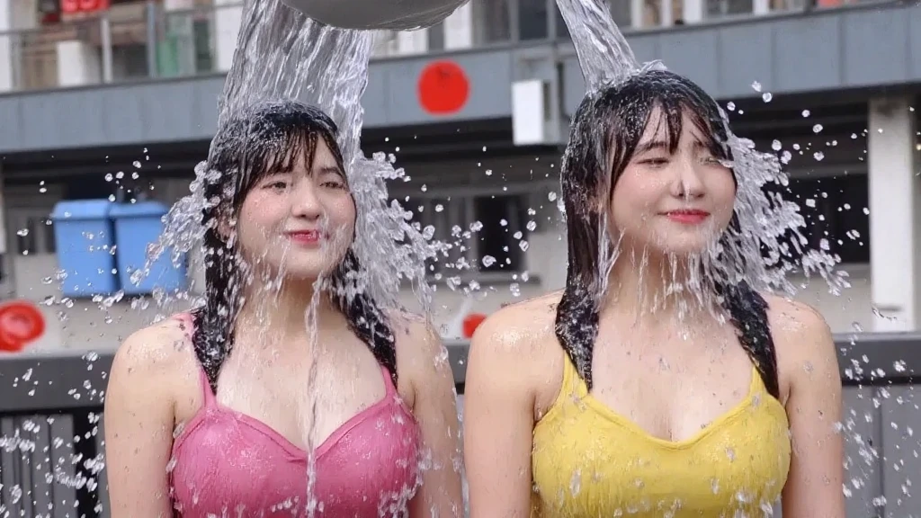 (competition, messy), (1woman), (swimsuit), (target of a pie throwing competition). Watch as she gets hit with an abundance of whipped cream pies to the face. It's a (messy game) and (wet and messy) experience that will leave you in stitches. (Pie throwing) and (pie fight), with (flying cream) and (thrown pies galore)