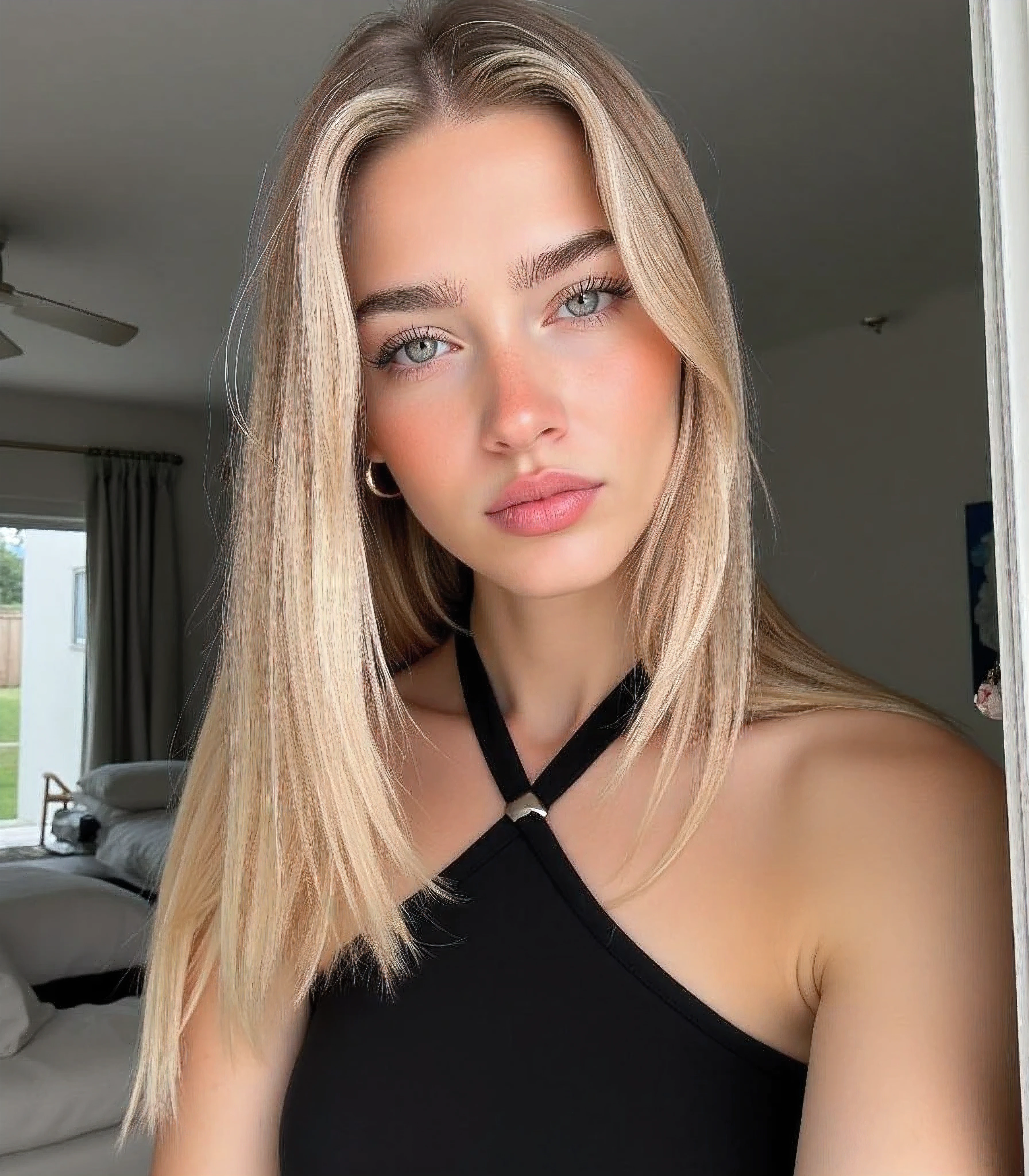 stunn1ng, bl0ndes, stunn1ng bl0ndes, bl0nde, a woman with long blonde hair and blue eyes wearing a black dress, 21 years old, Caucasian woman, sky blue eyes, soft pink lips, medium thick eyebrows with medium arch, pointy button nose, cut look, seductive look