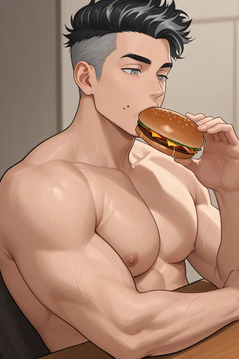 Handsome man sitting and eating fried chicken