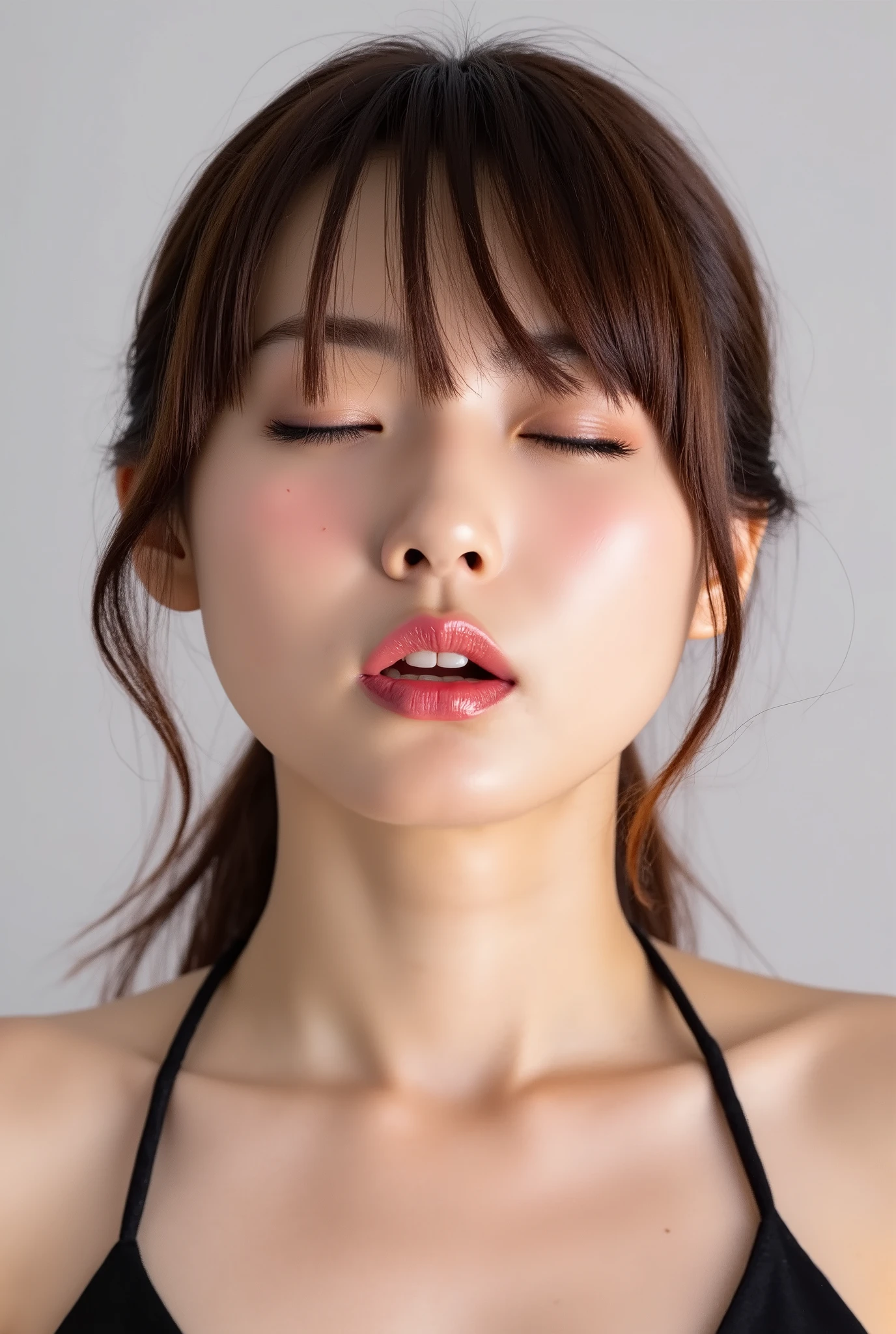 Japanese girl, head and collarbone in frame, black camisole, lips strongly pushed forward in a rounded puckered shape, circular kissy lips with intense gloss, lips as main focal point, soft pink wet lips with high-shine highlights, eyes closed with joyful smile, flushed cheeks and ears, dreamy and melting happy expression, slightly tilted head, natural unfiltered skin texture with faint peach fuzz, camera angle slightly above (35°), soft white studio background
