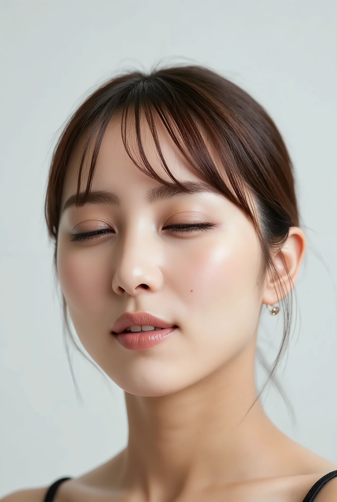 ultra-detailed close-up of a beautiful girl, collarbone-up composition, white studio background, soft natural lighting, slightly elevated camera angle (around 35 degrees), full face and head visible in frame, chin slightly raised, eyes gently closed, deeply affectionate smile, cheeks and ears flushed, dreamy, blissful, euphoric expression, mouth puckered and protruding with a rounded kiss shape, glossy moist lips with shimmering highlights, soft lips reflecting light, extreme focus on lips, inviting kiss pose, longing expression, desperate affection, dere-dere mood, hands behind her back and not visible, natural skin texture with visible peach fuzz, matte facial skin, black camisole strap visible, soft head tilt, bokeh background and soft facial contour blur to emphasize lips, overflowing with affection and dazed joy