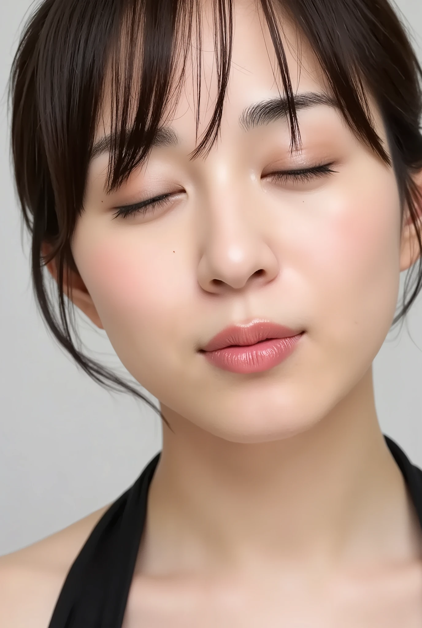 ultra-detailed close-up of a beautiful girl, collarbone-up composition, white studio background, soft natural lighting, slightly elevated camera angle (around 35 degrees), full face and head visible in frame, chin slightly raised, eyes gently closed, deeply affectionate smile, cheeks and ears flushed, dreamy, blissful, euphoric expression, mouth puckered and protruding with a rounded kiss shape, glossy moist lips with shimmering highlights, soft lips reflecting light, extreme focus on lips, inviting kiss pose, longing expression, desperate affection, dere-dere mood, hands behind her back and not visible, natural skin texture with visible peach fuzz, matte facial skin, black camisole strap visible, soft head tilt, bokeh background and soft facial contour blur to emphasize lips, overflowing with affection and dazed joy