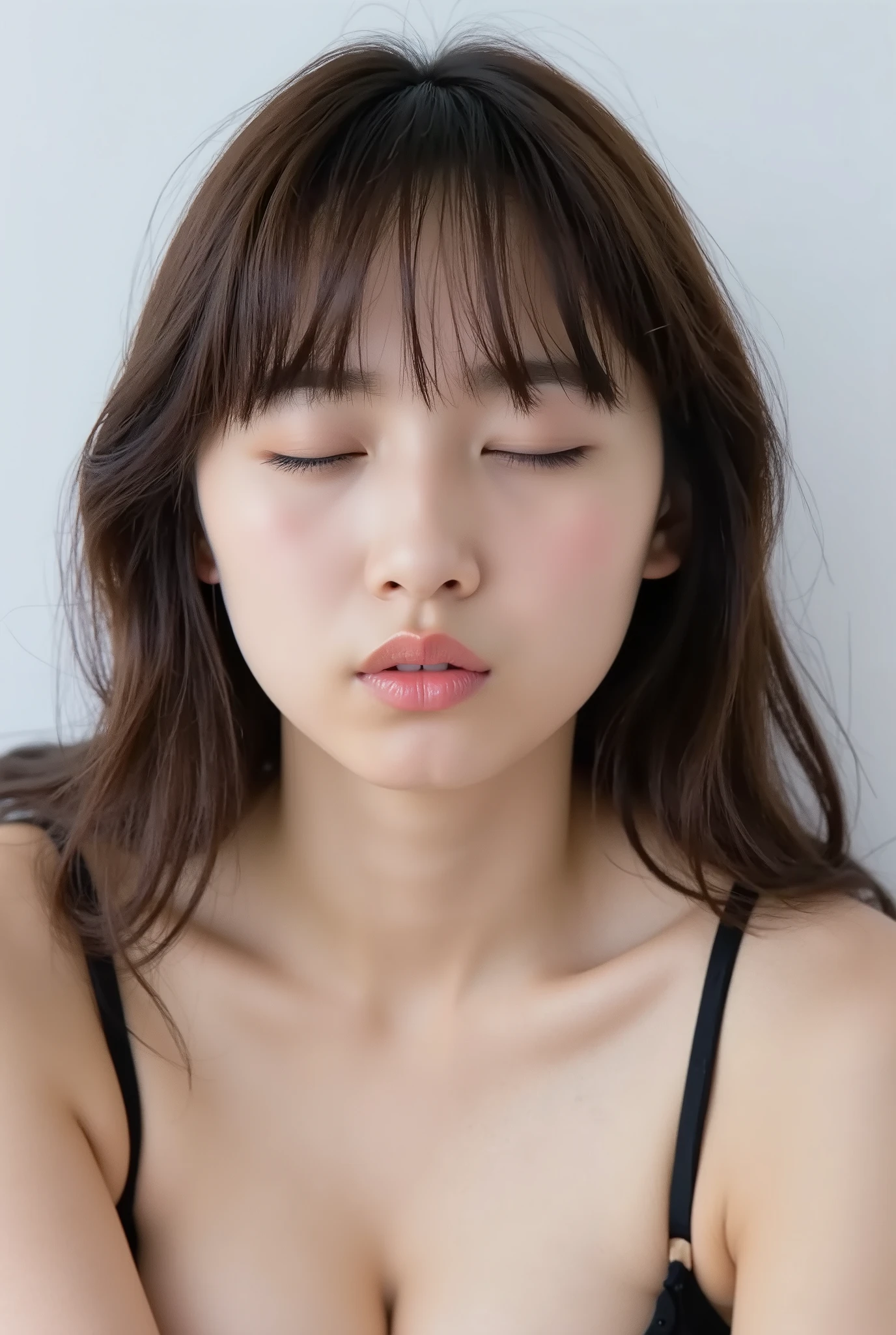 ultra-detailed hyper-realistic close-up of a stunningly cute girl, collarbone-up composition, white studio background, soft natural lighting, soft front-facing posture, head and body facing forward, chin raised slightly higher as if reaching for a kiss, head subtly tilted, black camisole strap visible, natural skin texture with visible peach fuzz, matte skin finish, hands behind her back and not visible

eyes gently closed, cheeks and ears flushed, soft affectionate and dere-dere expression, subtle closed-mouth smile without raised lip corners

lips tightly puckered and protruding upward and forward, forming a rounded vertical O-shape, strong gloss and shimmer, extremely moist and reflective, high contrast lip highlights, lips at the focal point with gentle facial blur, longing kissy face, overflowing with affection and warmth, inviting expression

photographed from a slightly elevated angle (~35-45 degrees above), showing entire face and head within the frame
