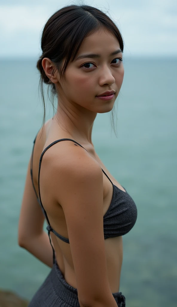 19 year old asian female beach wrestler injured after match. bruised. female medica holding her upper arms helping her walk. crowd in background