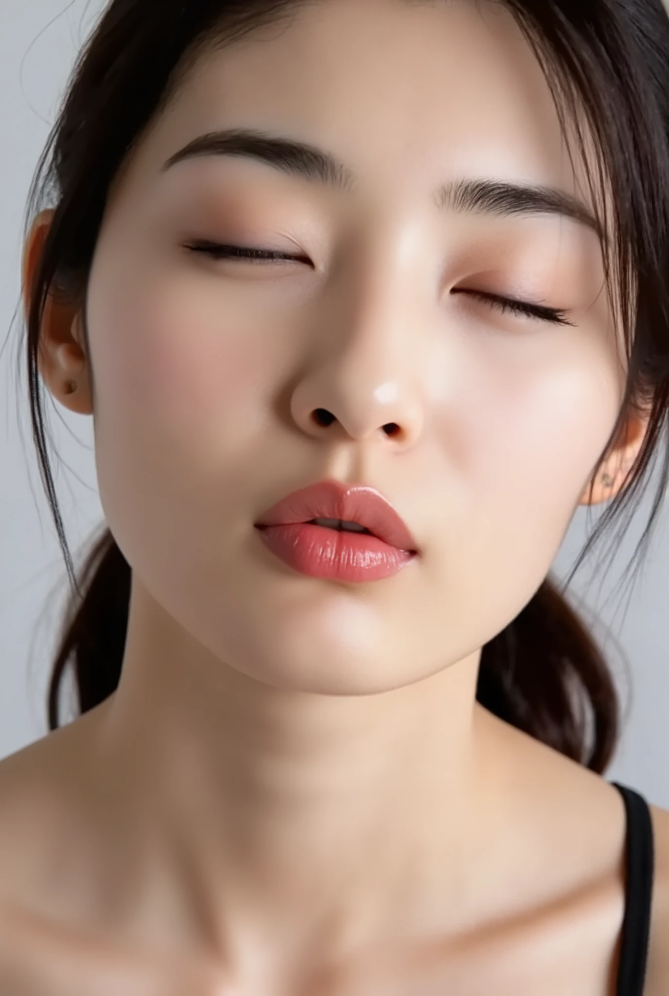 ultra-detailed close-up of a beautiful modern girl, collarbone-up composition, white studio background, soft natural lighting, soft focus on background, 
camera angle slightly elevated (about 60 degrees), subject's chin gently raised, head and face facing forward, body posture suggesting slight tiptoeing, 
eyes gently closed, dreamy and euphoric expression, cheeks and ears flushed with bashful blush, lips tightly puckered and strongly protruding, 
mouth forming a rounded "O" shape like whistling or blowing a kiss, kissy lips, extremely glossy and moist lips with shimmering highlights, 
natural-looking shiny lip gloss as the only makeup, skin is matte with visible peach fuzz and realistic pores, 
subtle facial contour blur to guide viewer’s gaze toward lips, cute and soft dere-dere mood, 
deeply affectionate smile while puckering, hands behind the back and not visible, black camisole straps slightly visible, 
overall overflowing with affection, adorably seductive and shy charm, longing and dazed joy, subtly coquettish expression, 
no vintage look, fully modern skin tone, hair texture and color corrected to current aesthetic standards
