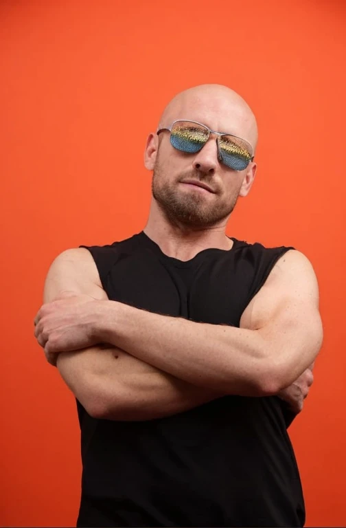 photo of Atate wearing a pink ballerina tutu, high quality photograph, bokeh, rim light, depth of field, analog, portra 800 film, bald man, sunglasses, chest tattoo, <lora:Atate:.7>