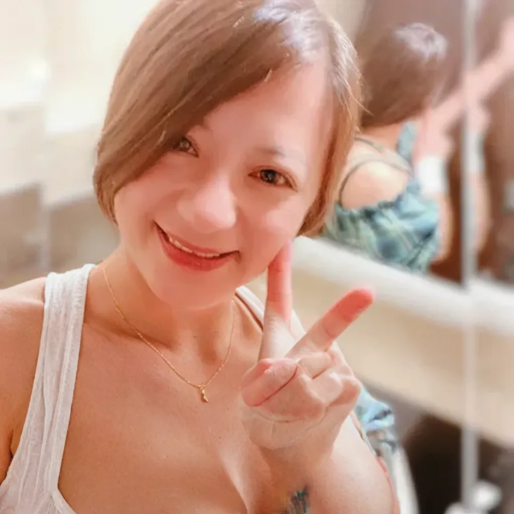 there is a woman that is making a mini love sign with her hand, 38 years old, (38 years old), with short hair