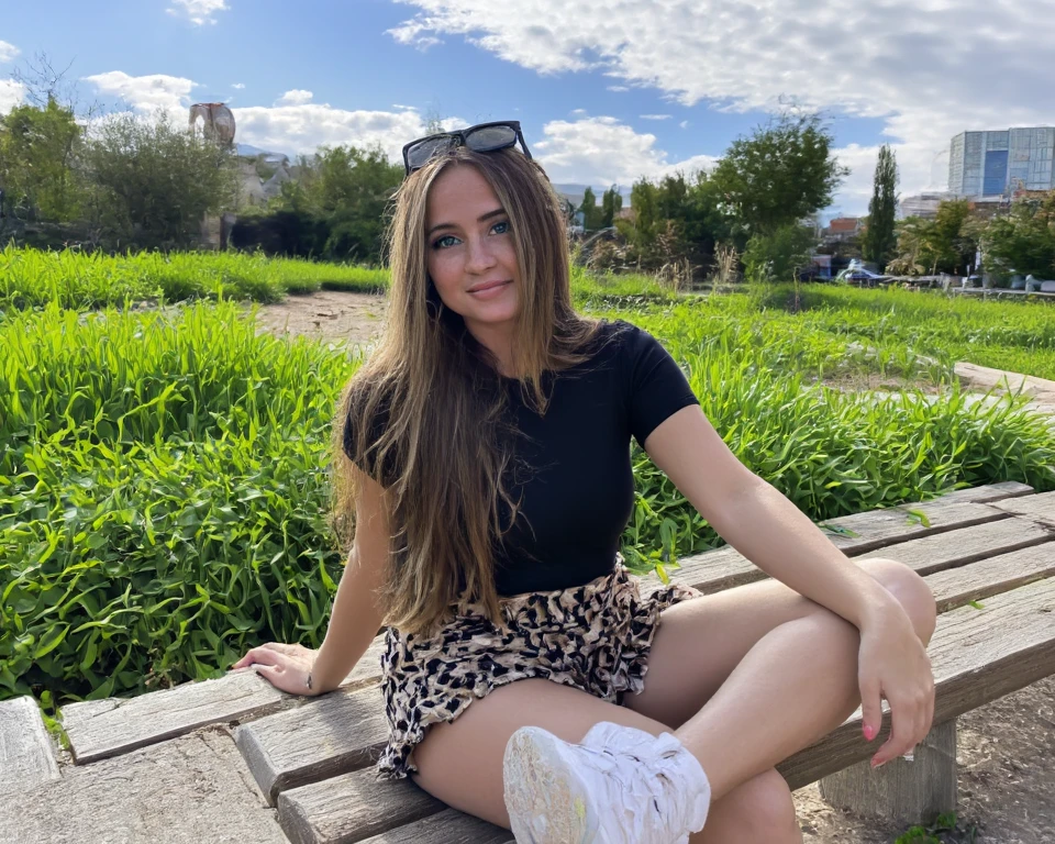 araffe sitting on a stone bench talking on a cell phone, wearing a camisole and boots, sexy look, green and black, wearing a camisole and shorts, pose casual, dressed in a top and shorts, black and green, chica sexy, she is wearing a black tank top, wearing a black camisole outfit, 🤬 🤮 💕 🎀