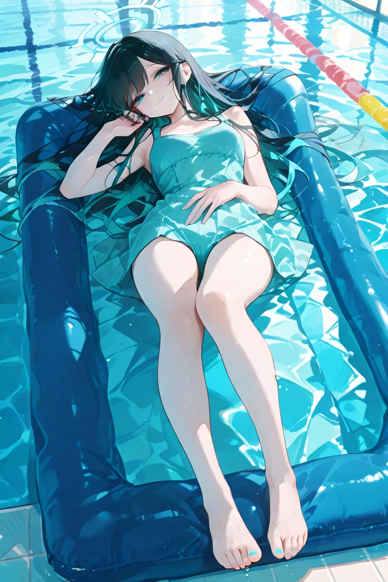 "A model sitting on the edge of a pool, feet in the water, looking down and playing with her hair."
