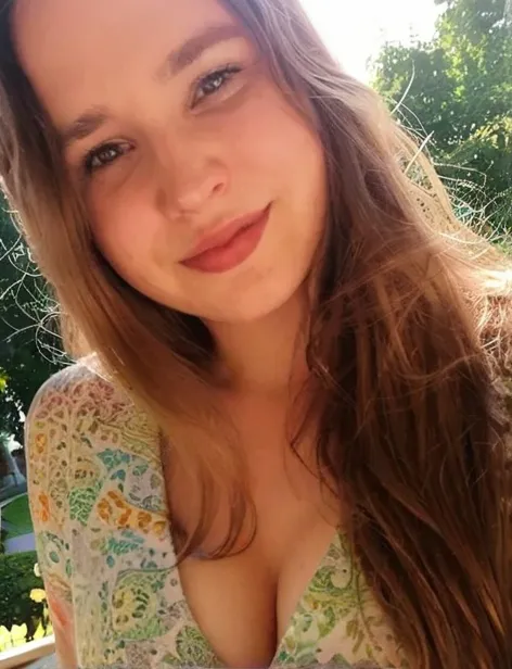 Exact same british young girl taking a selfie of herself wearing a beautiful blue floral dress in a beautiful garden, perfect and full body, curvy_hips, looking-at-viewer, light honey eyes, standing, mood lighting, Bokeh