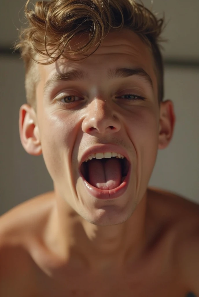 Attractive young man in boxers kneeling with his tongue out while looking directly at the screen