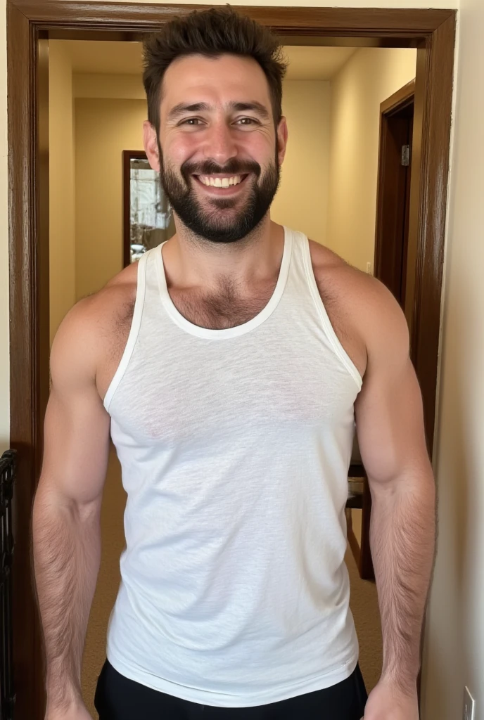 Foto de um homem de 40 anos com branco de pele clara e rosada, vestindo uma camiseta regata branca e usando um short curto de cor vermelha. Tem barba preta e cabelo curto, his chest is robust and his body is muscular, he also has a little belly. He is in a relaxed and carefree pose, the lighting is soft and studio, lembrando fotografias profissionais. The man looks like a daddy and is cute and sensual at the same time 