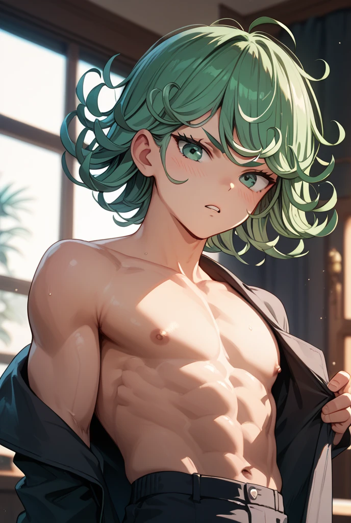 A naked man wearing only a yellow and green thong with his curly hair