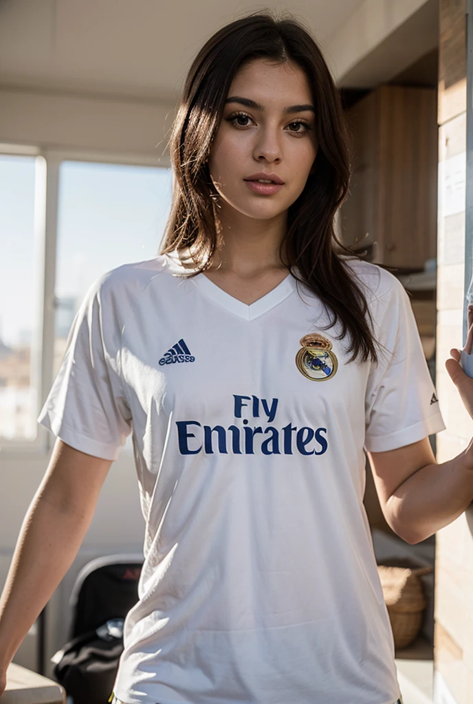Slim redhead woman with a big bust taking a photo wearing the Real Madrid shirt