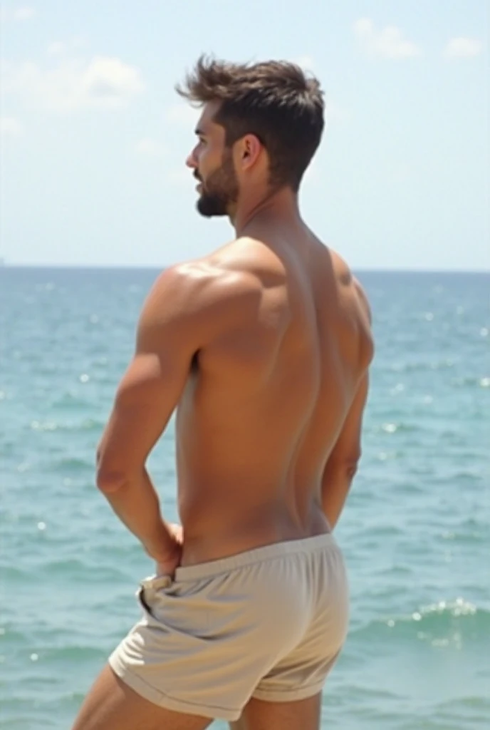 A men standing on sand of beach, facing towards beach enjoying beautiful view of beach, having great body features, round beautiful buttocks, thick thighs, beautiful legs, beautiful overall body.....