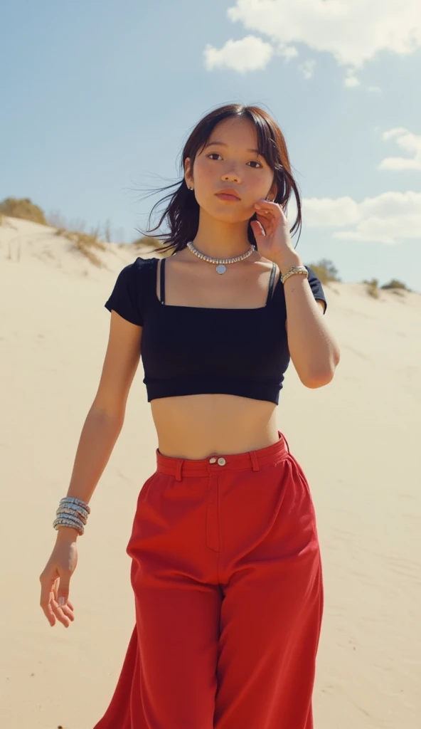 Miley Cyrus, personality, hair tied in a high ponytail, wearing a cropped tank top and shorts, sitting and posing seductively in the desert