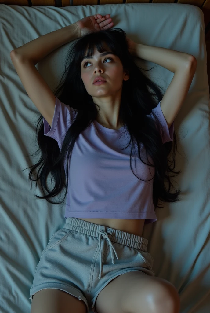 British lady with long black hair lying down in bed