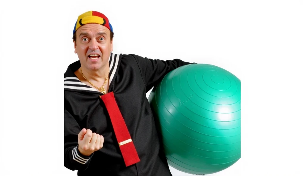 A man clown with big cheeks holds a blue balloon inside a trash can