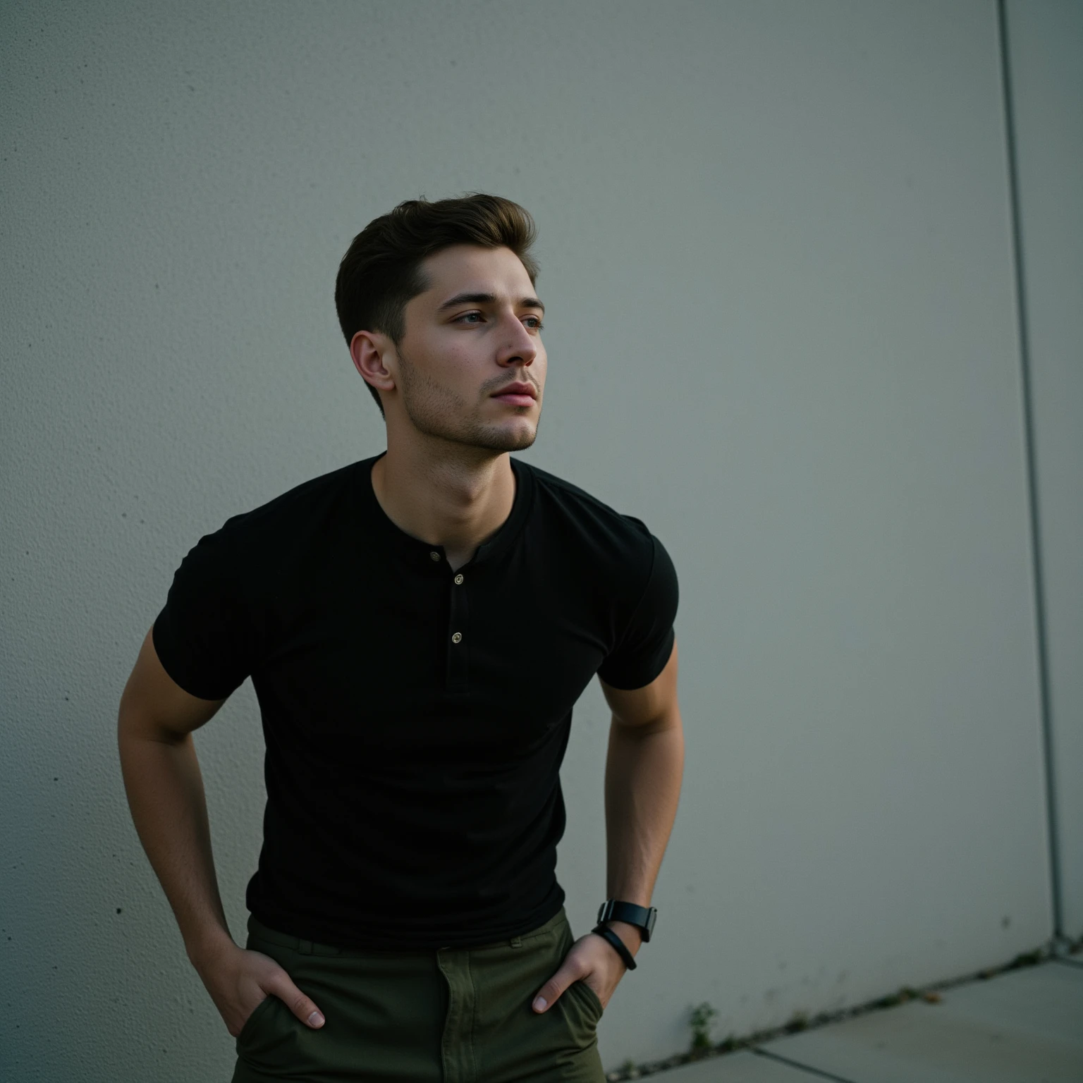 young Kalmyk, in a black T-shirt and green pants, smokes a cigarette, with black eyes, plump lips