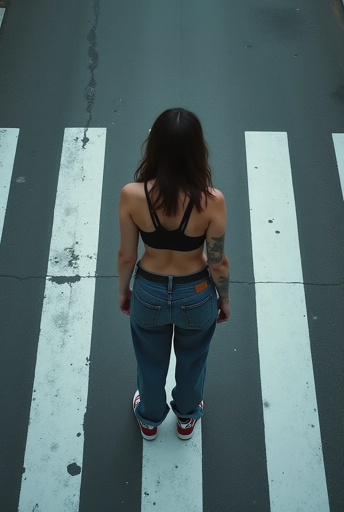 a girl with a slender figure stands with her back topless and in black pants and heels on a busy street