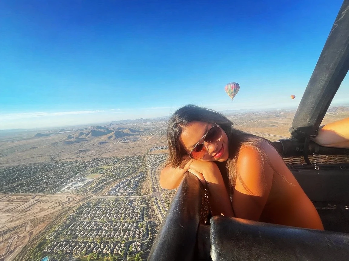 Leila Lopes on a hang glider completely naked and smiling