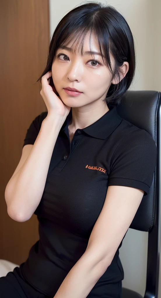 Caucasian woman with short hair sitting in the office in black polo shirt