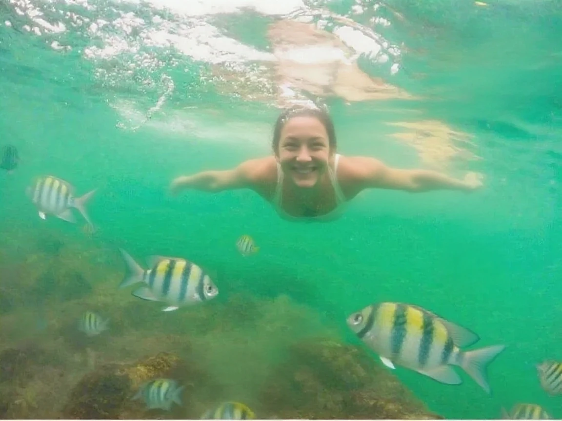 there are two people in the water with fish in the water, fish in the background, see fishes swimming, vacation photo, go pro, photo taken in 2 0 2 0, fish lens, in the middle of the ocean!!!!!, on the ocean water, stunning visual, by Carla Wyzgala, fish lense, gopro shot, lisa kristine, fish eye view