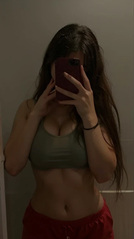 A side view selfie of a girl in a orange bikini