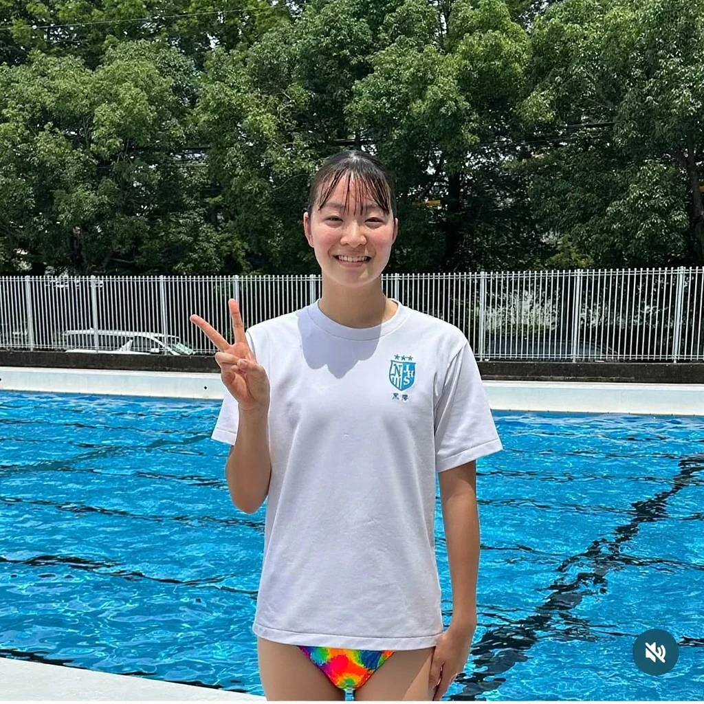 Little girl jumping into the water on the high platform of the pool