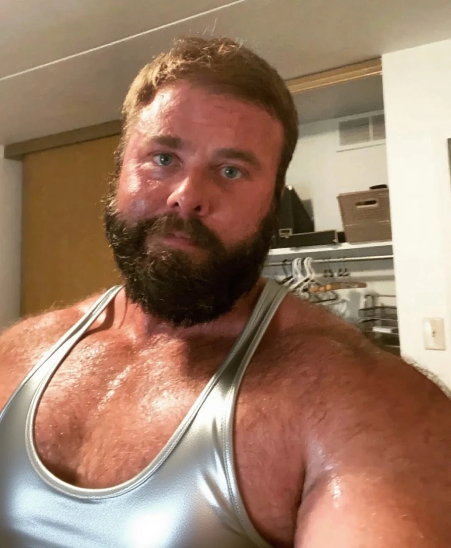 full body portrait, strong burly hairy mature older man(space captain), wearing futuristic captain's uniform insignia (neon and black) (open and revealing) (latex) , gray hair, broad shoulders, round belly, thick feet, bulging micro thong, barefoot, scifi spaceship captain uniform, neon lights, best quality elegant masterpiece, face looks like Tom Selleck (Magnum PI) , military buzzcut, dark mustache, gray stubble, latex, wearing a latex thong, big bulging crotch, futuristic gear equipment, wearing see through plastic chest armor (neon yellow and electric blue), wearing neon yellow see through chest armor, wearing electric blue latex chaps(see-through) , wearing cool neon sneakers,in spaceship cockpit, lying in spaceship sleeping quarters(bed) (view from above), smiling with teeth showing, nicebulge, waiting in bed, glowing armor, legs up(!) and spread(!) , big muscle ass, wet and dripping ass, visible asshole(!) , wet asshole, hairy pecs, thick long legs, silver hair