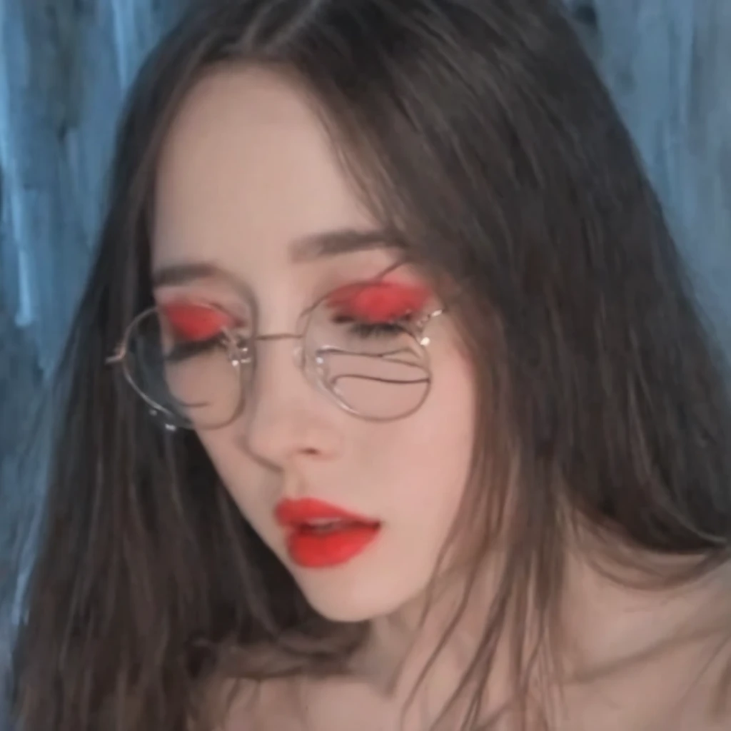 blurred background, long hair, eyes closed, Teeth, round lenses, eye shadow, lunar under the eye, interiores, Red lips big boobs staring at me while touching her pussy