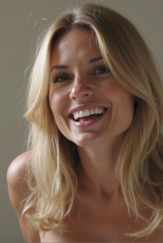 Delta Goodrem on her knees completely naked and smiling