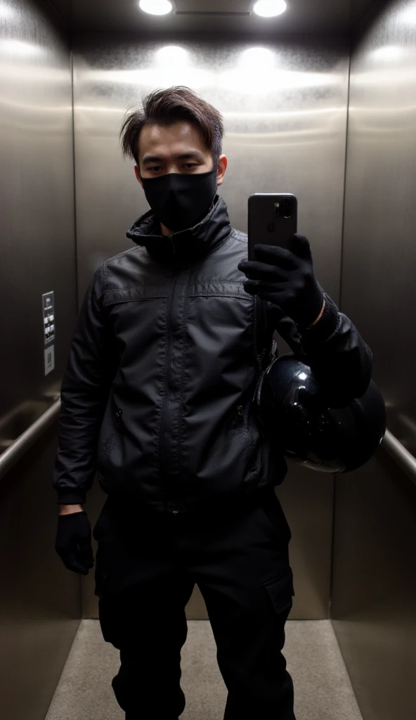 The image shows an individual taking a mirror selfie inside an elevator, dressed in dark, functional attire, suggesting preparedness for outdoor activities or travel. The overall aesthetic is sleek and somewhat mysterious due to the obscured face.The person is holding a smartphone up to take a mirror selfie, obscuring most of their face, with only their eyes and forehead visible above a mask or neck gaiter.

- Attire: They are dressed predominantly in black clothing, which appears to be designed for warmth and utility:

- Outerwear: A black, slightly glossy or water-resistant jacket with a high collar, possibly a lightweight puffer or windbreaker.

- Face Covering: A black mask or neck gaiter covers the lower half of their face.

- Gloves: Black gloves are worn on both hands, contributing to the utilitarian aesthetic.

- Bottoms: Black pants, likely track pants or tactical trousers, with subtle texture or design elements.- Smartphone: A dark-colored smartphone, possibly an iPhone given the visible camera bump, is held up for the selfie.

- Bag/Helmet: The person is carrying a black, shiny object that strongly resembles a motorcycle helmet or a duffel bag made of a similar glossy material, slung over their shoulder or held by their side. Its reflective surface adds to the visual interest.

- Hair: Dark hair is visible above the face covering, appearing slightly styled or wind-swept.- Elevator: The setting is clearly an elevator, indicated by the polished metallic walls (likely brushed stainless steel) and the presence of an elevator control panel with buttons on the left side.

- Lighting: The lighting inside the elevator is even and somewhat soft, reflecting off the metallic surfaces.
