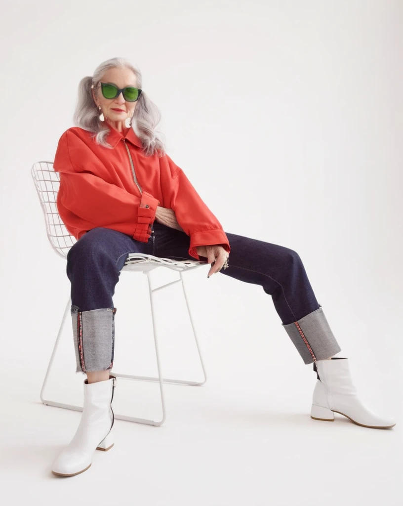 Iris Apfel standing wearing a high-class tennis outfit holding a tennis racket, an award-winning fashion photo, a wide full body portrait, large glasses, hat, jewelry, large screen television on the wall in the background, even studio light, photorealistic Goerz Hypergon 6.5mm f/8