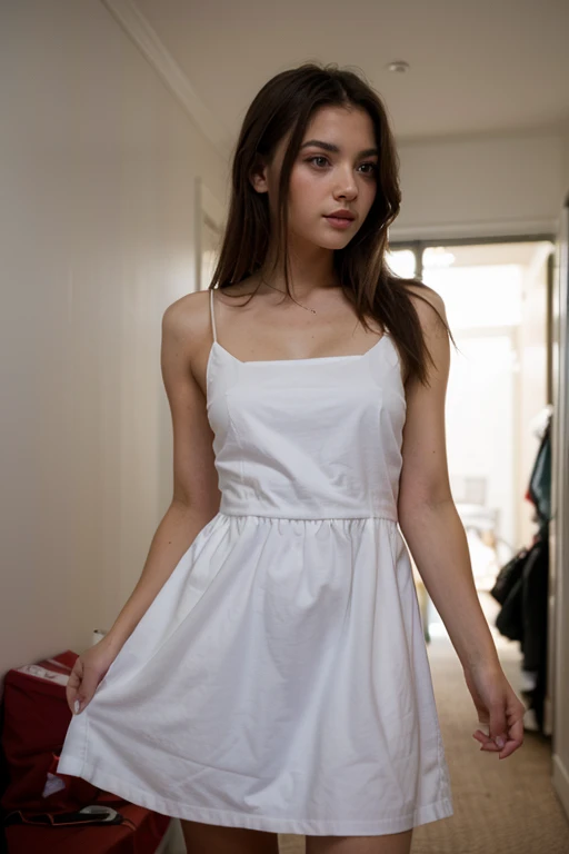 White woman with long brown curly hair, wearing dress with pokies