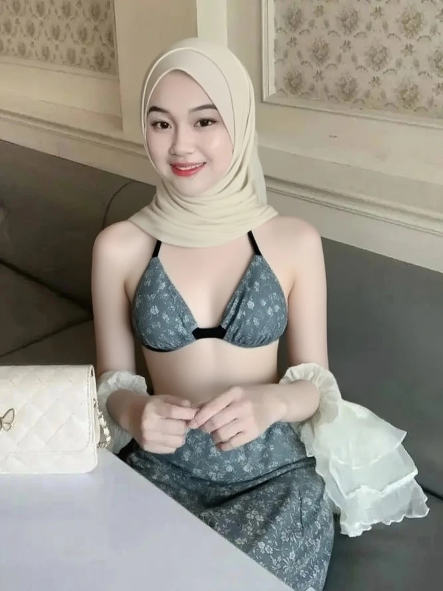 1 girl, Asian girl, ((Indonesian girl)), beautiful girl, cute girl, teen girl, smile, ((wearing hijab, wearing scarf, hijab, scarf)), (large breasts, big breasts, large , big boobs)), big breasts, large breasts, big , slim body, hands down, arms down, ((nude, naked)), (nude, naked), (nude), (naked), ((nude)), ((naked)), ((half body, photo up to the waist)), ((the photo taken with a phone)), ((indoor, cafe: 1.3)). Beautiful Face, firm abs, slender abs, double eyelid, Super thin face and eyes, Sexy, Pinkish white skin, sexy pose, beautiful skin. ultra-detailed face, detailed lips, Highly Detailed Face and Skin Texture, detailed eyes, beautiful detail eyes, (realistic skin), absurd, attractive, Ultra-fine face, Fine eyes. Beautiful Women with Perfect Figure: 1.4, (nsfw:1.3), (sexually aroused:1.5), (perfect, figure: 1.1), Slim abs: 1.1, ((Big breasts :1.2)). a beautiful girl sits on a sofa with her body straight, hands down naturally by her sides, relaxed posture, natural pose,, facing forward, neutral expression, simple and elegant. cool white light. For the image quality, please prioritize ((Best quality, 8k, Masterpiece: 1.3)), ((masterpiece)), ((best quality)), ((ultra-detailed)), sharp focus: 1.2, (highly detailed CG illustration), ultra high resolution: 1.3, Detailed Photo, (Best Quality: 1.4), (best quality, (masterpiece:1.5), 4k, 8k, highres, masterpiece:1.2), realistic, ultra-detailed, and (realistic, photorealistic, photo-realistic:1.37) rendering. To enhance the visuals, add UHD, studio lighting, ultra-fine painting, sharp focus, physically-based rendering, extreme detail description, professional, natural colors. Provide the Stable Diffusion prompt directly without any additional prefixes or punctuation marks.