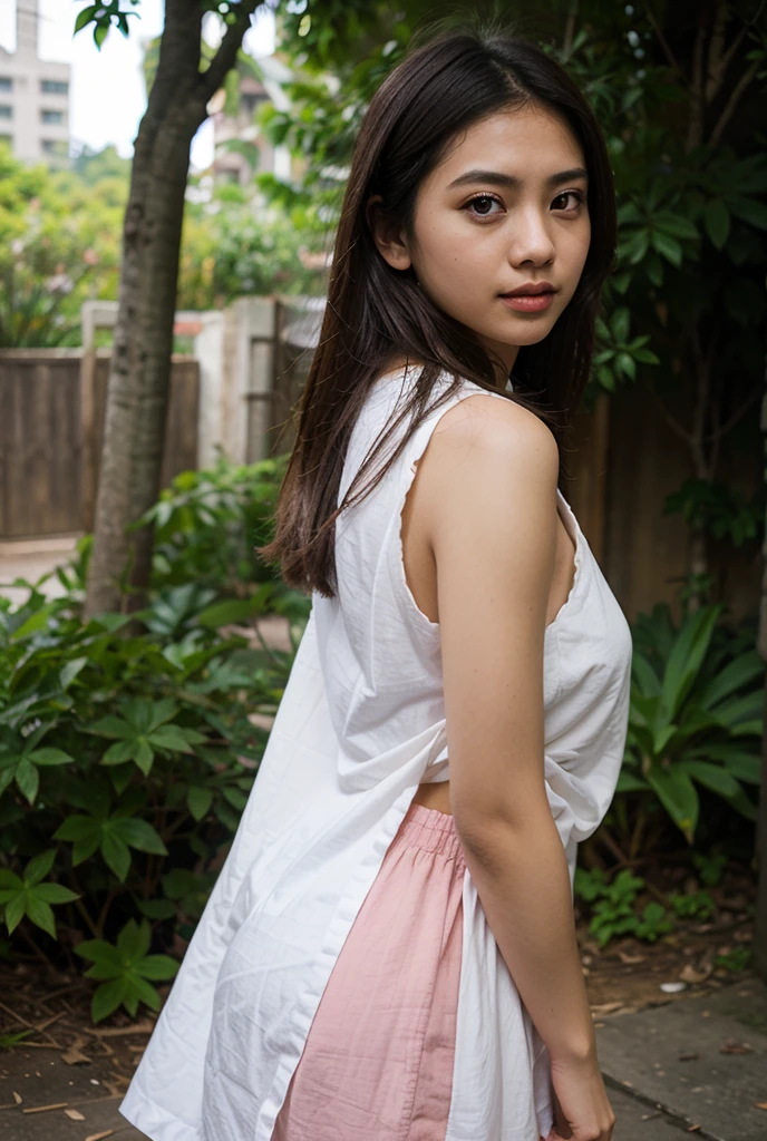 Wanita itu memiliki rambut hitam panjang yang tergerai anggun tertiup angin pantai. Ia mengenakan kemeja lengan panjang berwarna pink yang menonjolkan keindahan kulitnya, dengan rok bermotif bunga yang menjuntai lembut di tepi pantai, menciptakan image menawan di bawah sinar matahari sore.