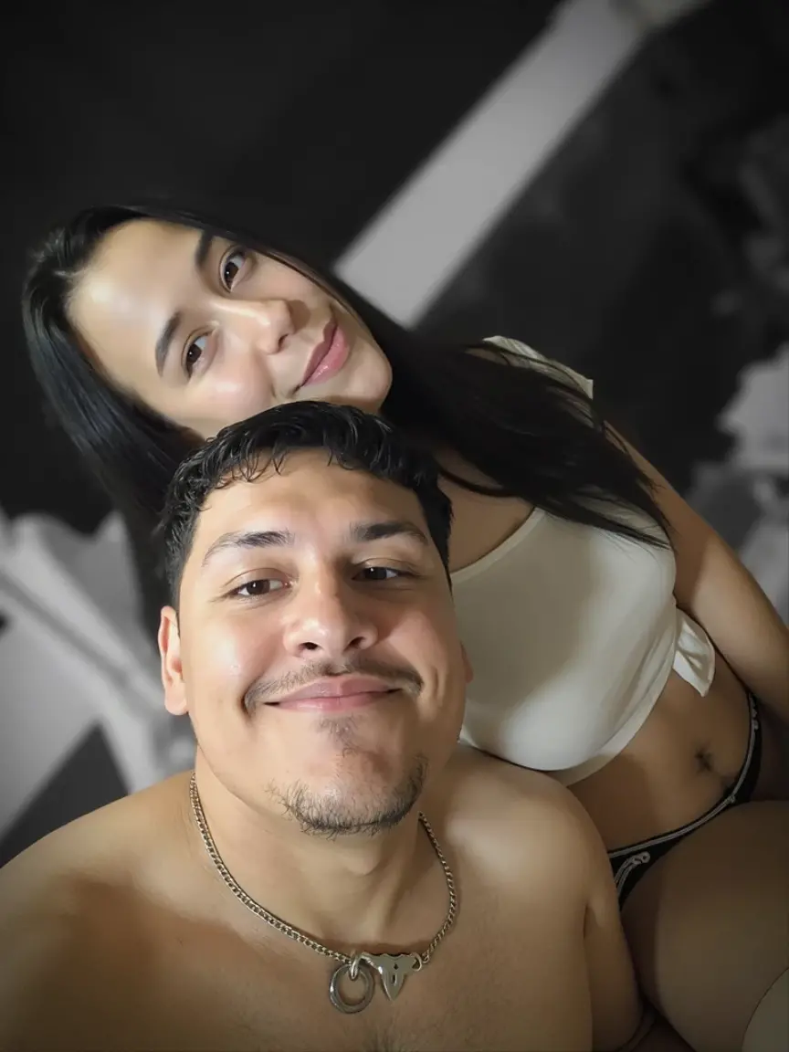 smiling couple sitting on sofa in living room with mirror in the background, vacation photo, momma and papa, imagem de perfil, foto do perfil, retrato de casais, photo from behind, Directed by: Nandor Soldier, com verruga, 4 k post, Postagem 4k, Mulher de 30 anos de Cuba, foto do perfil 1024px, foto de baixa qualidade