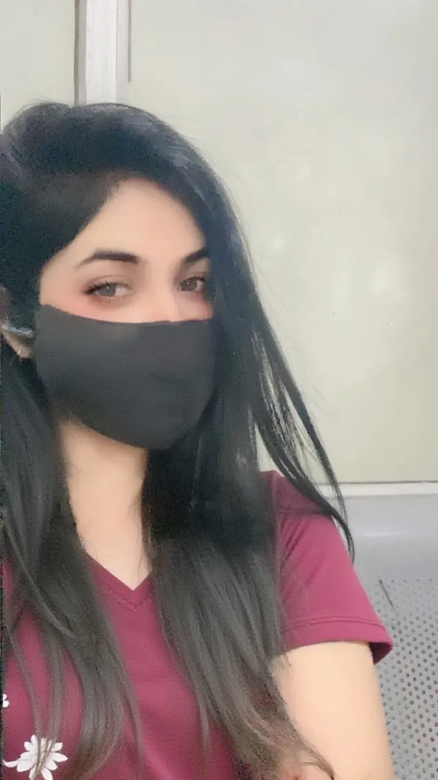 There is a woman with a girdle around her neck and a black shirt, profile picture, 30 year old woman without makeup, profile picture, wearing white color mask, 8K photography, has to get ultra realistic, amazing modeling of the incredibly realistic person, close to reality.