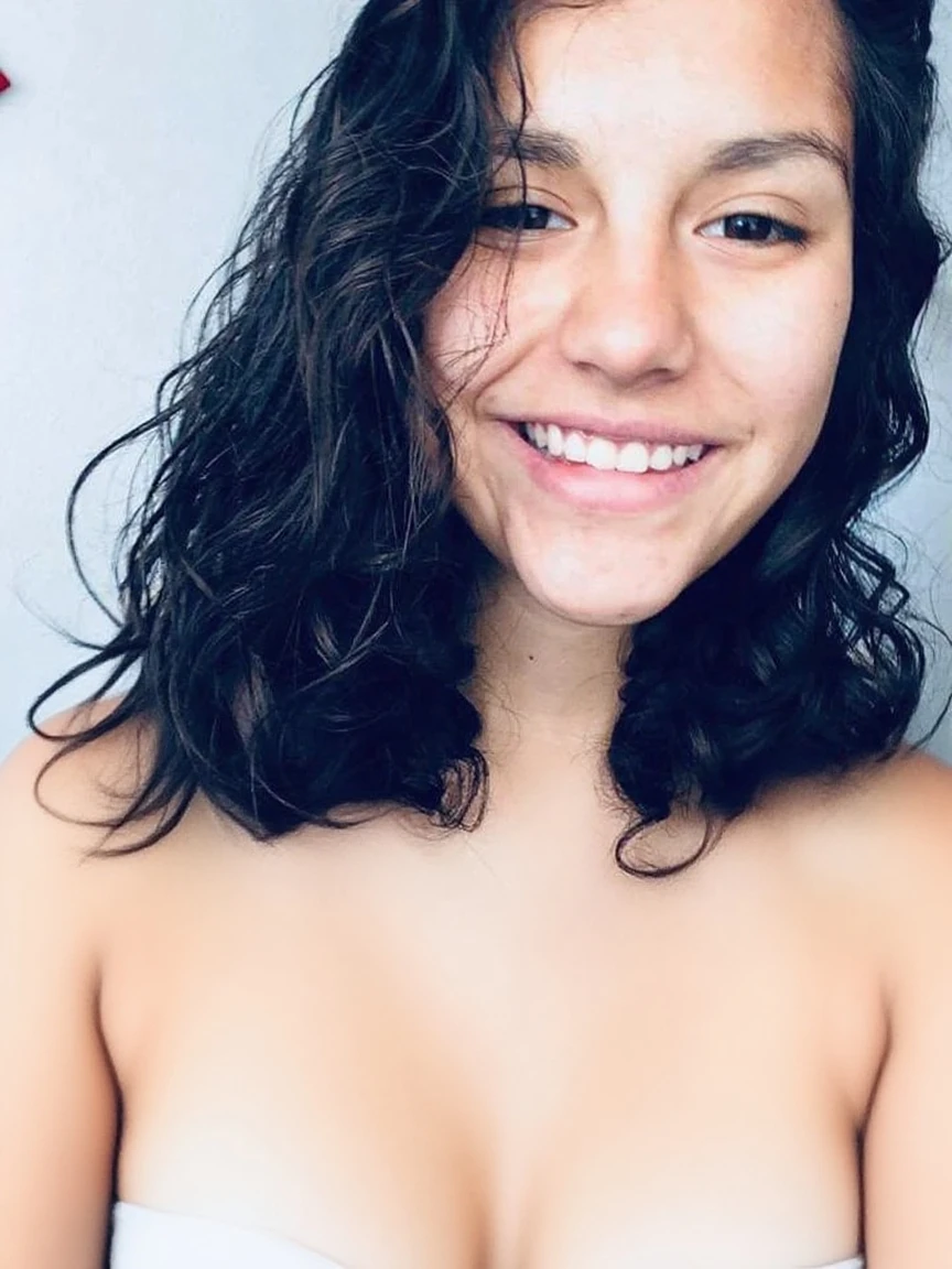 Leaked selfie of a cute sexy 19 year old hispanic girl , on a Discord video call, thick wavy black hair, smirking, long eyelashes, naked