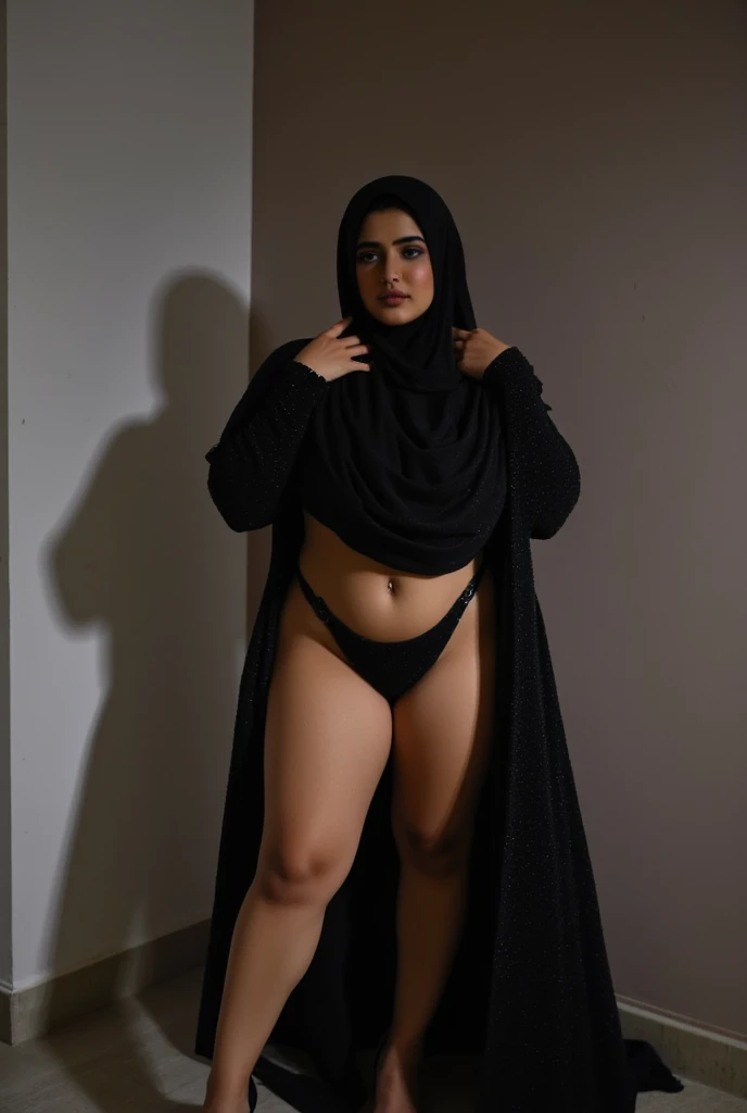 RAW photo,dark,moody,hazy atmosphere,35mm focal lenght,underexposed,cold,candid photograph,artistic,full body,photo of a beautiful,influencer,30yo Iranian woman,black, hijab,detailed skin,naked, looking away from viewer, thick body structure,grey background,no background, candid pose,dim room,blue light, film grain, kodak color, instagram LUT