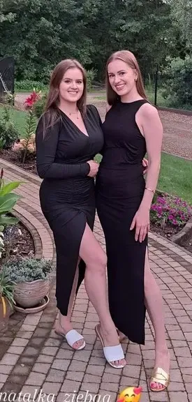 two women standing next to each other in a park, ruan jia and mandy jurgens, wearing a formal dress, wearing a cocktail dress, wearing a black dress, ayami kojima and lyde caldwell, waist high, wearing dresses, profile picture, in the background, formal attire, two girls, wearing black dress, wearing a dark dress, thick thighs, wide hips, Big tits, huge tits, no clothes, sexy, cute, minimal clothes, thick, bbw, chubby stomach, thick nipples, nipple piercings, large areola, hard nipples, piercing through shirt, nipples hard through shirt, busty, major cleavage, naked, ripping through top,  spilling over sides, bra too tight, giant tits, extra wide hips, upper body zoom in, showing off huge tits, fat stomach, see through top, fat bbw, large areola showing