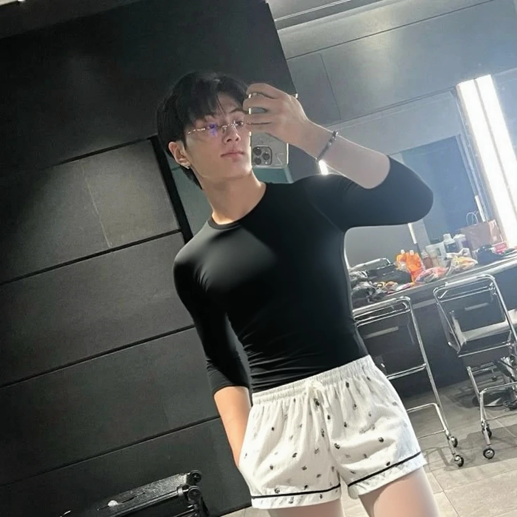 12-year-old boy, bursting big black balloon between legs, wearing speedos, shirtless, abs, thin body, hugging big black balloons, popping big black balloons, handsome, youthful, boyish, cute, black military sunglasses, photography, realistic, indoor soft lighting