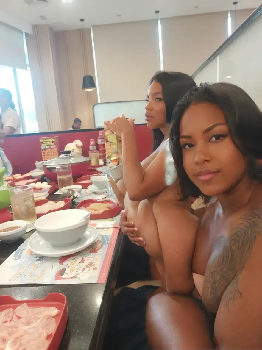 a big ass naked really skinny slim young tribal black woman with wide hips and short hair sitting down a beach, perfect big round ass, highest quality, 8k, flat chest, visible bones of the shoulder, visible ribs, visible back bones, same escale as the other women, being the daughter of the older woman