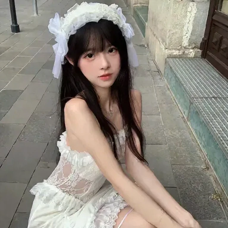 The camera slowly zooms in, revealing a woman in a white dress and a white headdress squatting on the street. Colorful ghost images slowly spread from the woman and the background, creating a cscy effect.