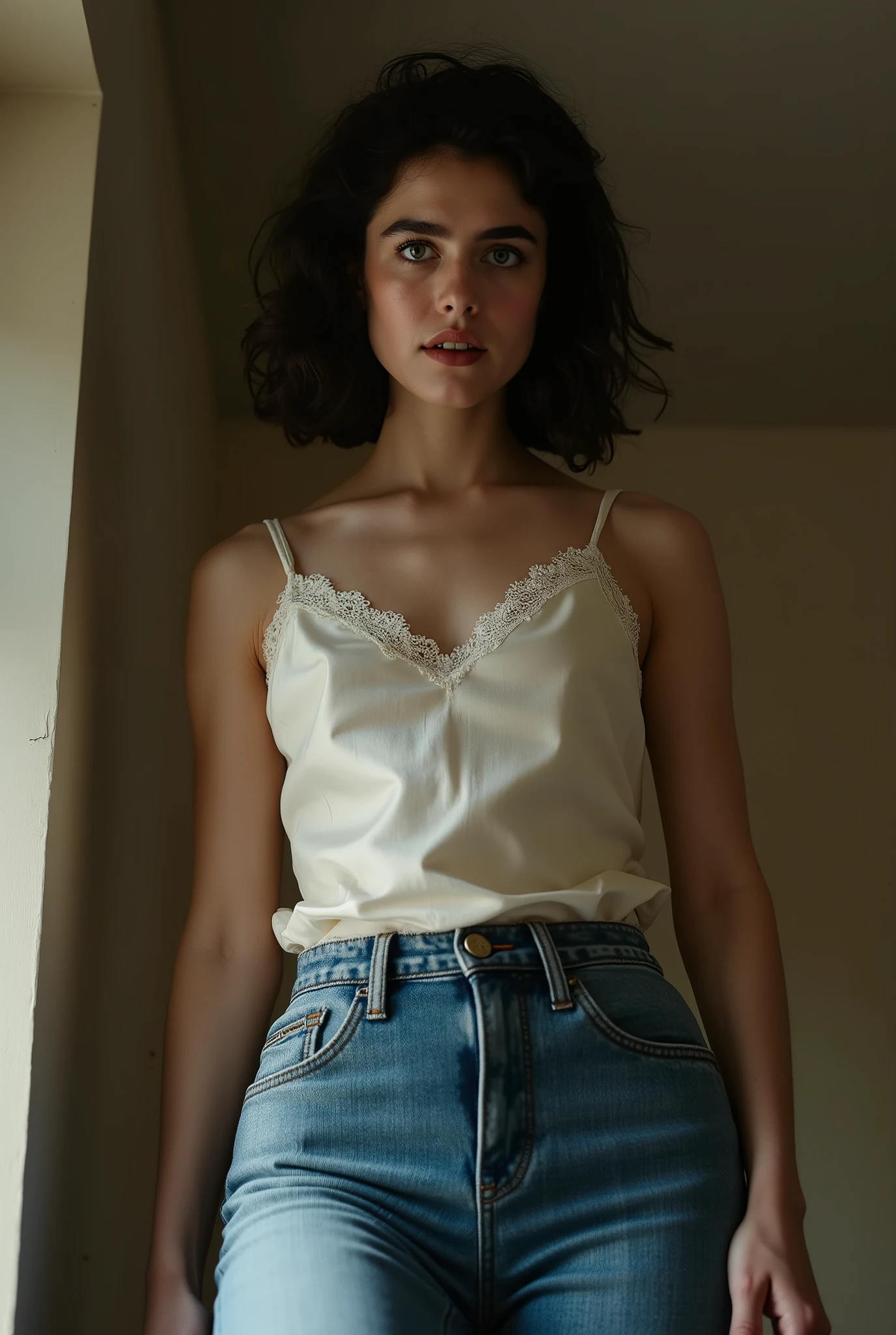 photorealistic portrait, extreme low-angle full-body shot from below the knees, looking up, making her appear towering and overpowering, dominant young woman standing over the viewer, radiating strict authority, intimidation, and psychological control, wearing an elegant ivory silk-satin camisole with delicate lace trim, no collar, no visible buttons, tucked into form-fitting high-waisted skinny jeans emphasizing her curves, piercing, unyielding gaze locked on the viewer, expression cold, stern, and menacing, body language rigid and precise, shoulders squared, chest slightly forward, posture perfect and assertive, hands with subtle tension, fingers poised to assert control, intimate framing pulling the viewer into her space, natural daylight casting dramatic highlights and shadows accentuating silk, lace, denim, and strict figure contours, minimal props, focus entirely on her dominance, strict authority, and magnetic, intimidating presence, cinematic, commanding, and unforgettable.