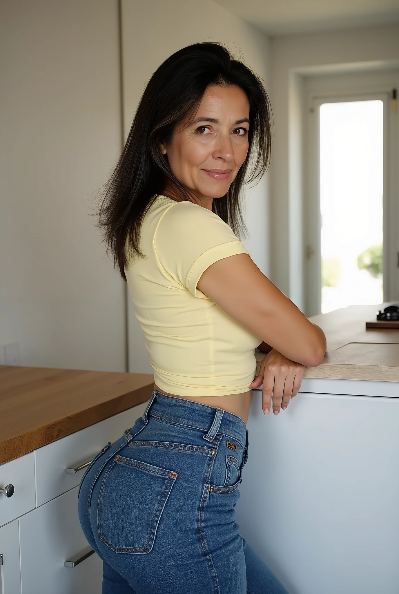 milf,amat3ur7 ,Candid moment of mature beauty, 61 years old, mid-thigh-up framing, full figure visible from head to upper thighs, rear shot, visual focus on her , narrow waist, round , she is glancing over shoulder. Long, straight black hair with hints of grey, side-parted, hair flowing down to waist. Wearing a pale yellow fitted t-shirt, t-shirt has short cap sleeves and is tucked into high-waisted tight-fitting jeans. Crow’s feet adding character, naturally aged skin with visible fine lines and texture. She leans casually against a kitchen counter, self-possessed and confident, mature aura, looking directly at viewer, Set in a clean, modern kitchen, morning light streaming in to highlight authentic features. Contemporary documentary photography style, ultra high resolution, highly detailed textures in hair, skin, and fabrics.
