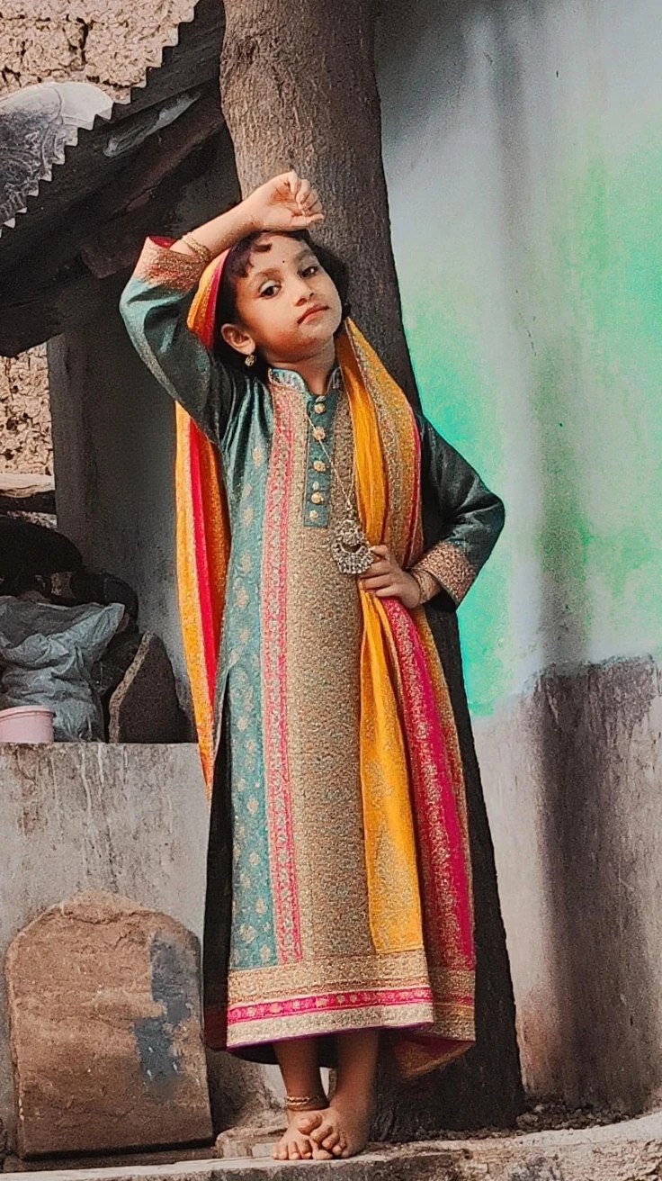 arafed girl in a blue shirt and a colorful skirt holding a doll, wearing bihu dress mekhela sador, wearing traditional garb, in a fancy dress, costume, wearing a fancy dress, traditional dress, traditional costume, in costume, traditional clothes, traditional beauty, cute beautiful, wearing an elegant tribal outfit, dressed in a sari, tai costume