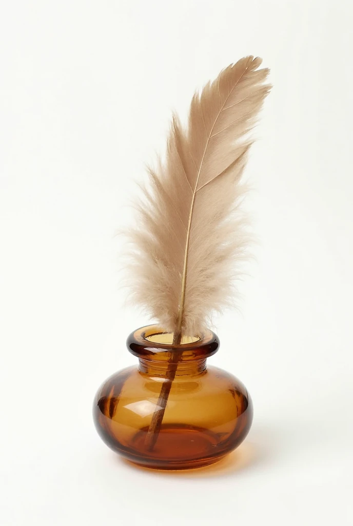 Brown fluffy feather in an old amber inkwell on a white background ...